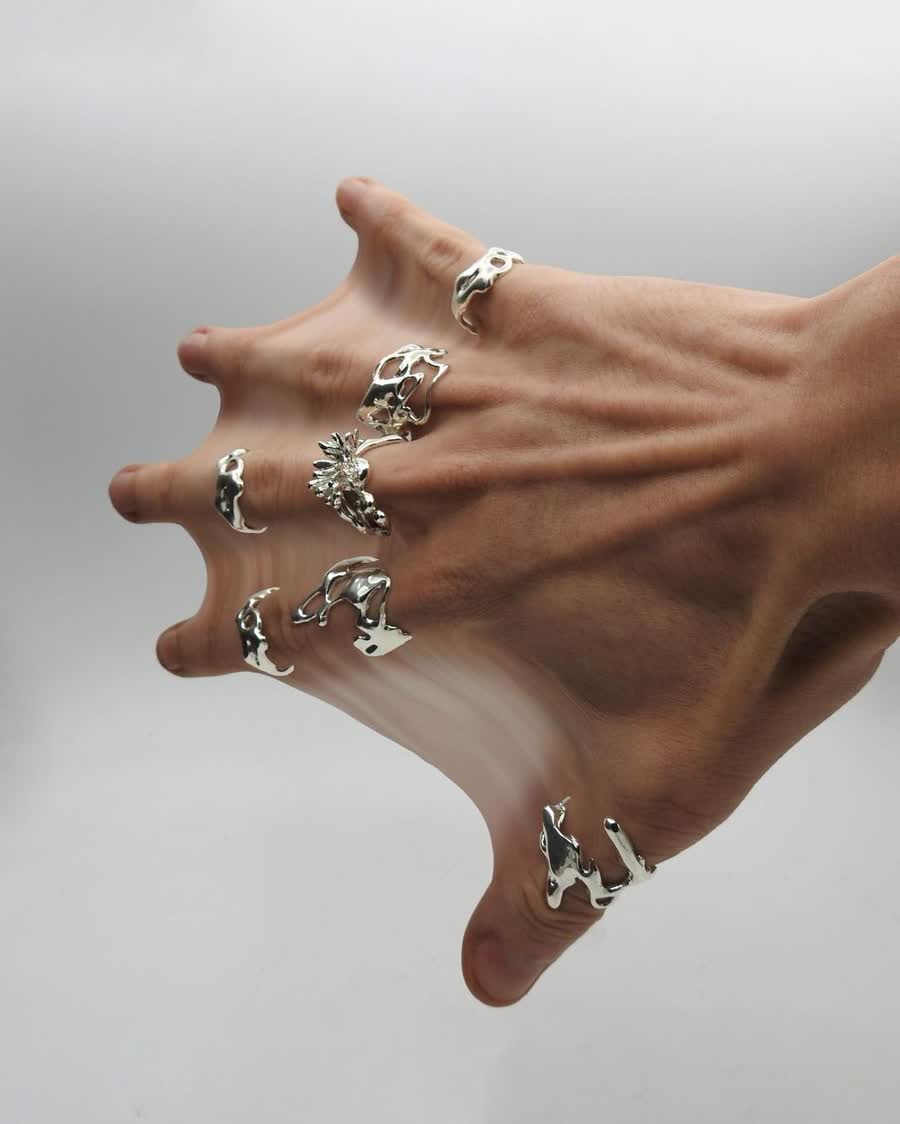 Liquid silver rings over a stretched hand