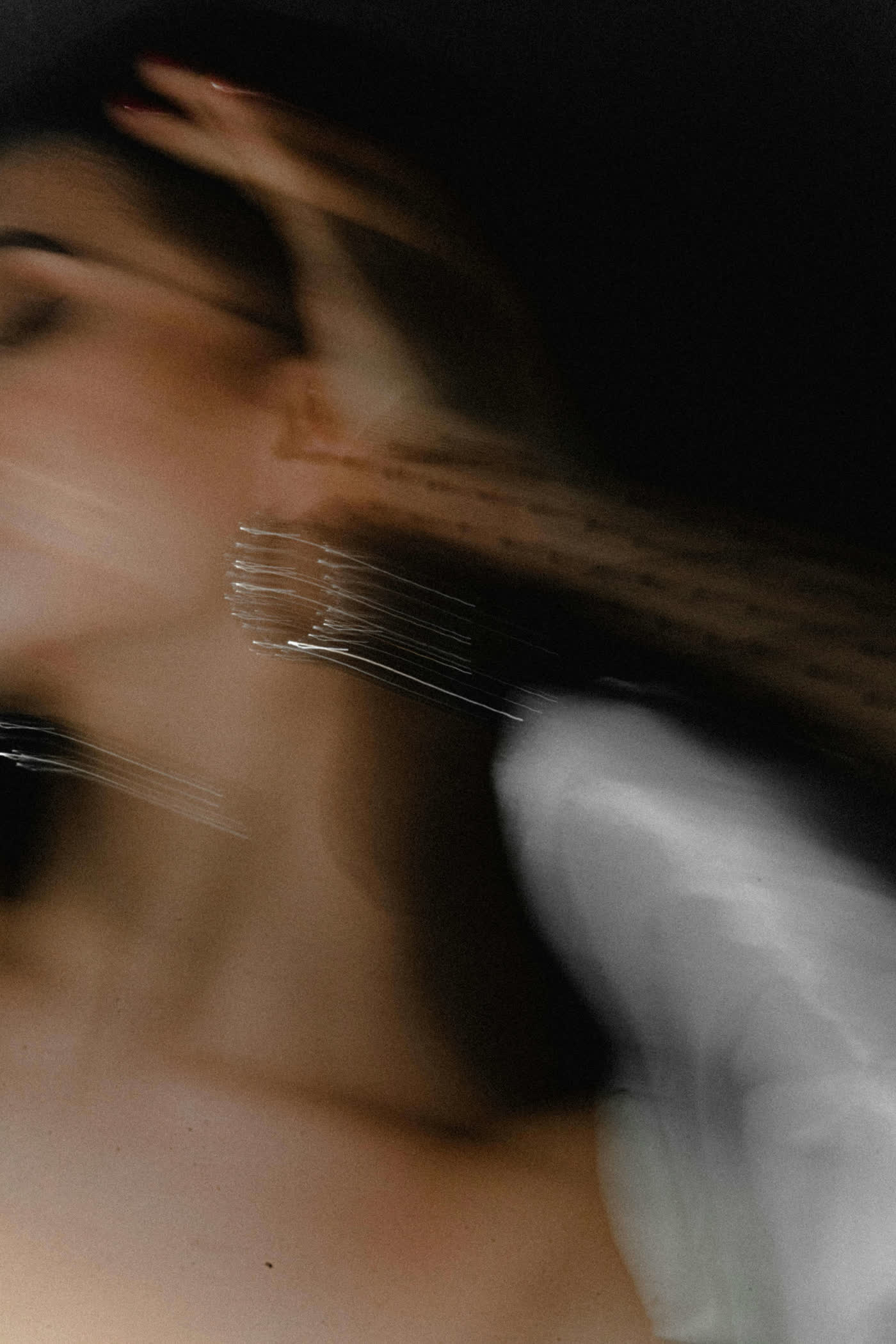 Blurred motion portrait wearing sculptural jewellery